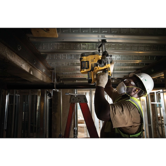 Dust extractor for MAX SDS hammer being used by person Dust extractor for MAX SDS hammer being used by person