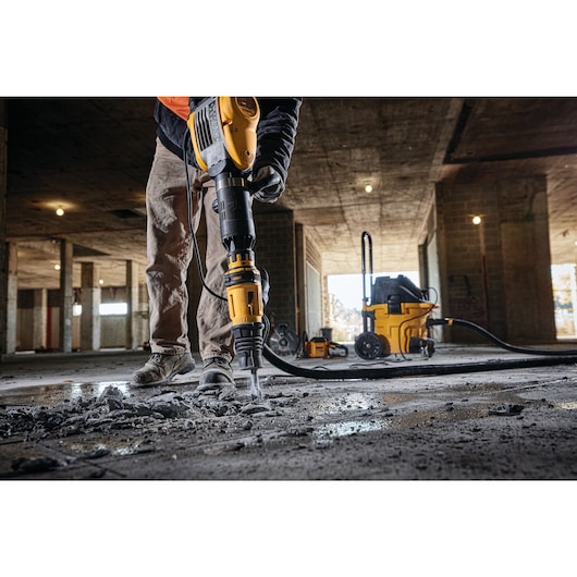 SDS MAX Demolition hammer being used by person SDS MAX Demolition hammer being used by person