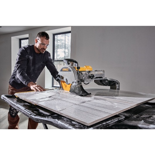 High Capacity Wet Tile Saw being used by a construction worker to cut square tile