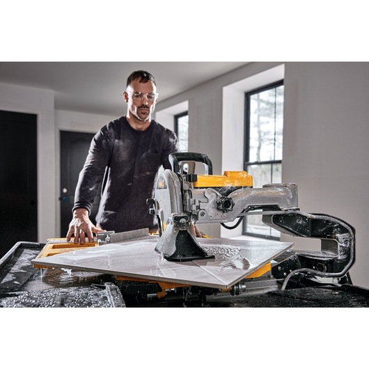 High Capacity Wet Tile Saw being used by a person in front view High Capacity Wet Tile Saw being used by a person in front view