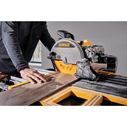 High Capacity Wet Tile Saw being used to cut a tile High Capacity Wet Tile Saw being used to cut a tile