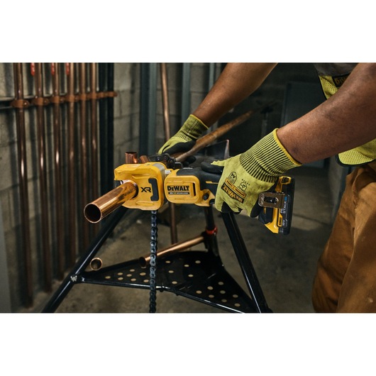 DEWALT 18V XR Brushless Copper Tubing Cutter being used to cut copper pipe on jobsite
