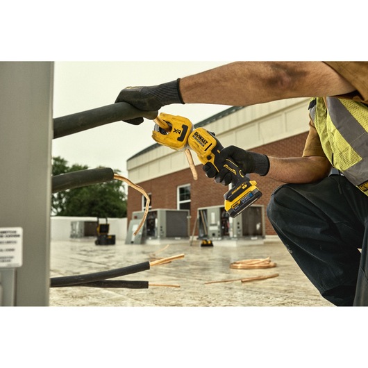 DEWALT 18V XR Brushless Copper Tubing Cutter being used to cut soft copper pipe from HVAC system
