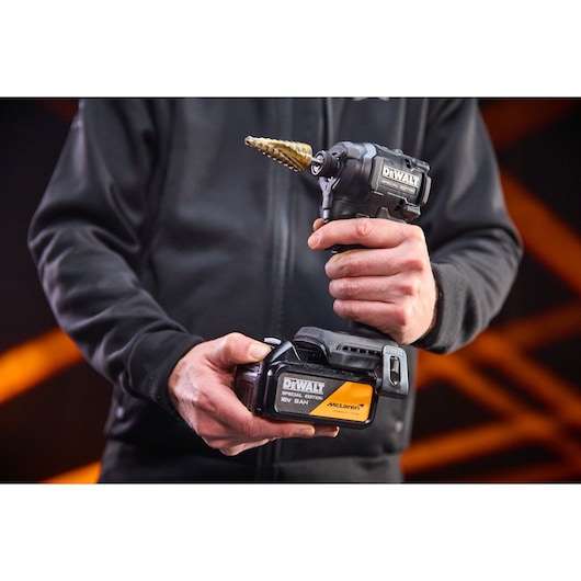 5Ah battery being connected to the DEWALT x McLaren F1 Team 18V XR Special Edition Impact Driver