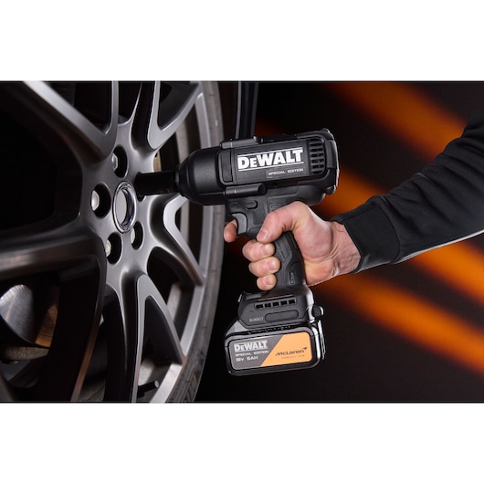 DEWALT x McLaren F1 Team 18V XR Special Edition Impact Wrench with 5Ah battery tightening a wheel nut