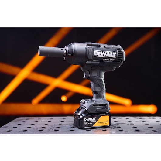 DEWALT x McLaren F1 Team 18V XR Special Edition Impact Wrench with 5Ah battery standing on a metal sheet