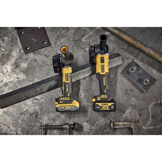 DEWALT 18V XR Brushless Compact 125mm Angle Grinder and DCG407 DEWALT 18V XR Brushless Angle Grinder on metal background