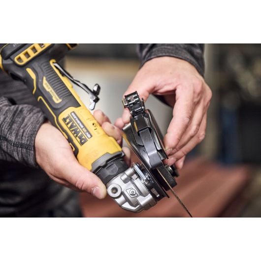 Cutting guard being attached to the DEWALT 18V XR Compact 125mm Angle Grinder with 3.5ah battery