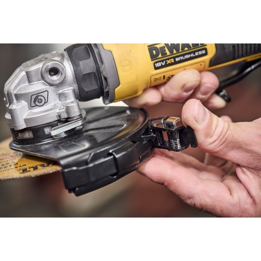 Cutting guard being attached to the DEWALT 18V XR Compact 125mm Angle Grinder with 3.5ah battery