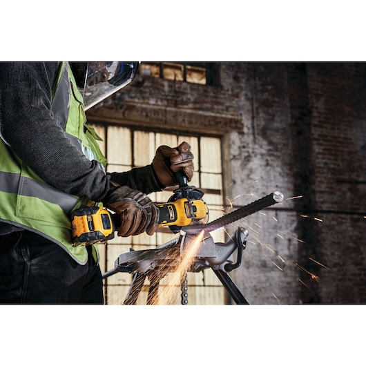 A tradesman using a DCG409VSN to cut rebar