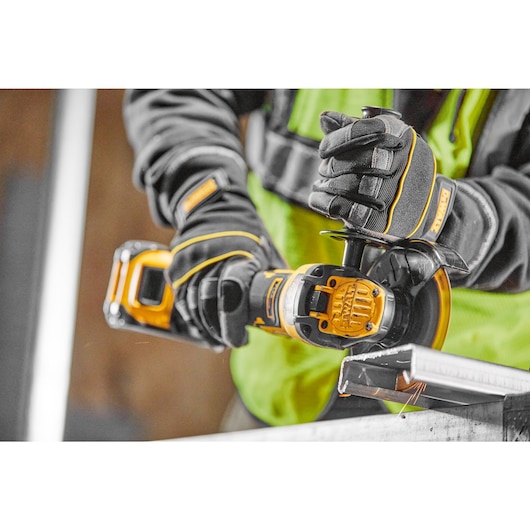 A TRADESMAN USING A DCG409VSN TO CUT CABLE TRAY