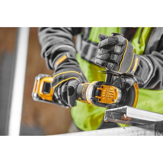 A TRADESMAN USING A DCG409VSN TO CUT CABLE TRAY