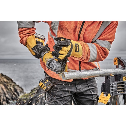 6 INCH CORDLESS GRINDER WITH KICKBACK BRAKE being used by a workman on a snowy work site