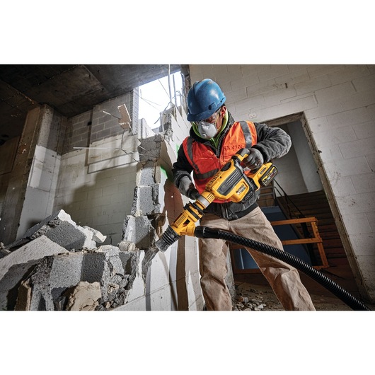 Brushless, cordless SDS MAX combination rotary hammer being used by a person