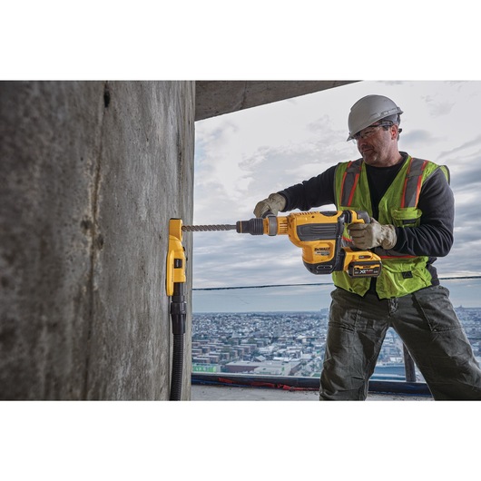 Brushless, cordless SDS MAX combination rotary hammer being used by a person