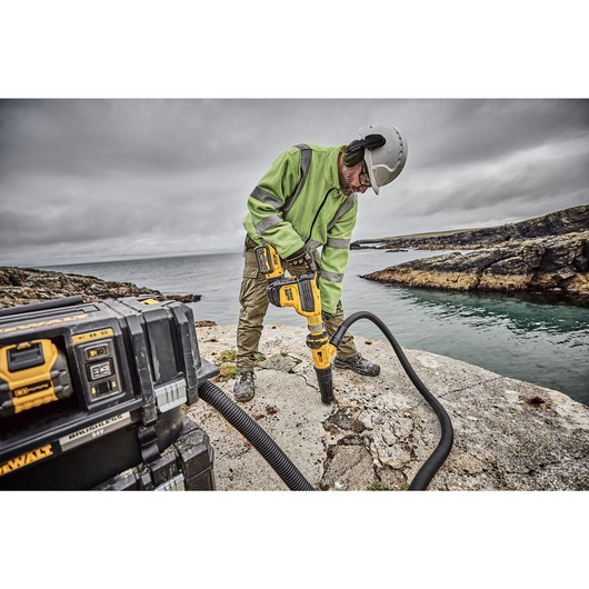 Brushless, cordless SDS MAX combination rotary hammer being used by a person