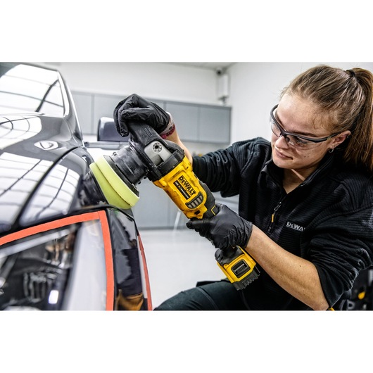 XR cordless variable speed random orbit polisher being used by a person to polish a car