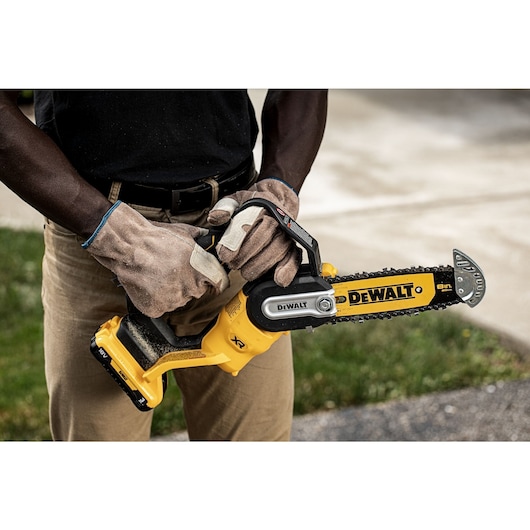 Worker holding an 18V XR Brushless Chain Saw