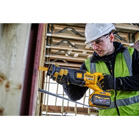 FLEXVOLT brushless cordless reciprocating saw being used by person.