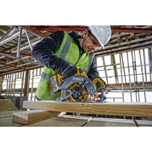 FLEXVOLT brushless cordless circular saw with brake kit being used by person on wood.