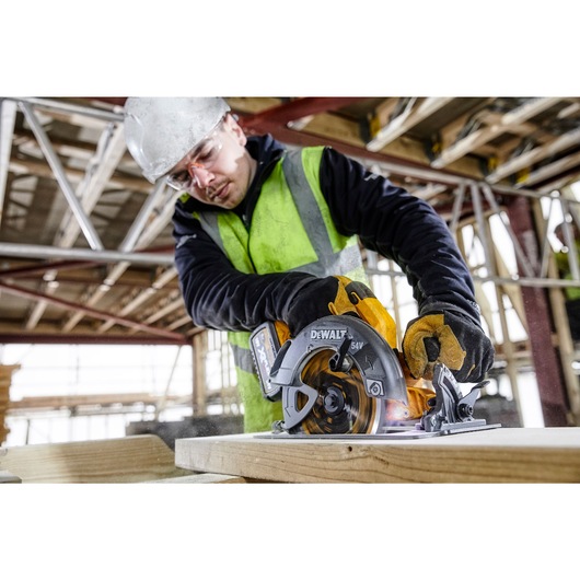 FLEXVOLT brushless cordless circular saw with brake kit cutting wood at an angle.