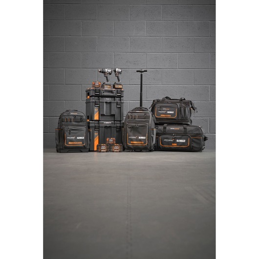 Limited Edition DEWALT/McLaren storage bags, Tstak trolley, impacts and accessory boxes stand in front of a grey wall.