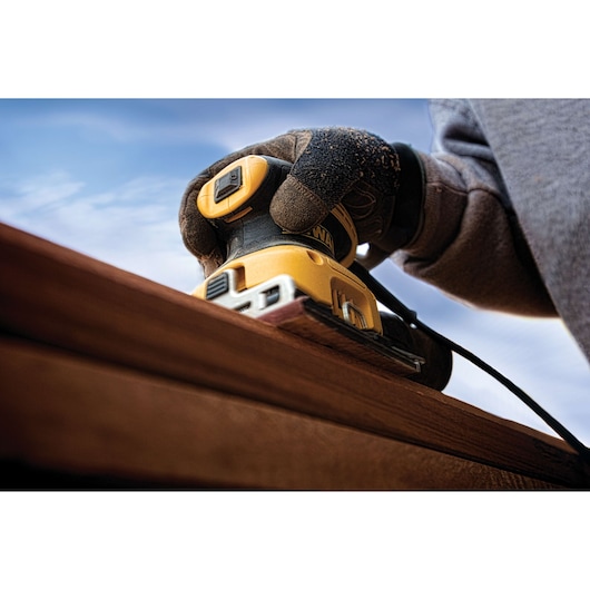 One quarter inch sheet palm grip sander in action on wood. One quarter inch sheet palm grip sander in action on wood.