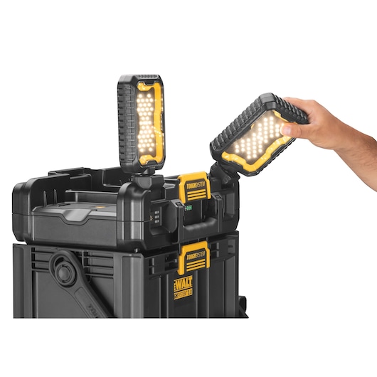 Side view of the TOUGHSYSTEM 2.0 Cordless Adjustable Work Light and Storage with adjustable headlights on and being angled