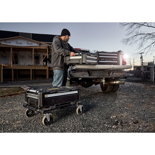 Someone pulling a DXL 2 drawer toolbox out of the truck bed