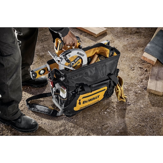 Circular saw being pulled out of the Dewalt 20" Pro Open Mouth Tool Bag"