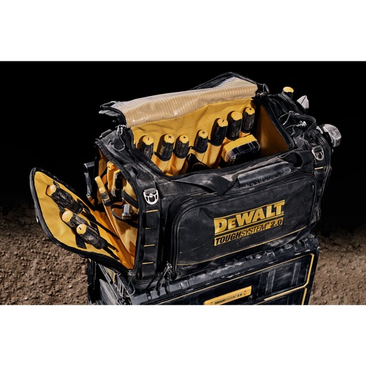 Three quarter view of open DEWALT TOUGHSYSTEM 2.0 22-inch jobsite soft storage toolbag holding DEWALT screwdrivers and other hand tools. Three quarter view of open DEWALT TOUGHSYSTEM 2.0 22-inch jobsite soft storage toolbag holding DEWALT screwdrivers and other hand tools.